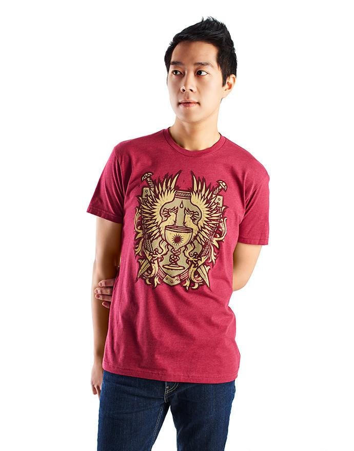 An image of the Grey Warden Heraldry shirt. It is heather red, featuring the Grey Warden heraldry on the front.