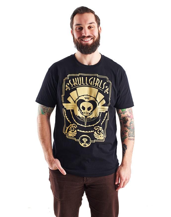 The Skullgirls Deco shirt is black, with an art deco design across the front. The title "Skullgirls" adorns the top of the design. In this image, it is worn by a model.